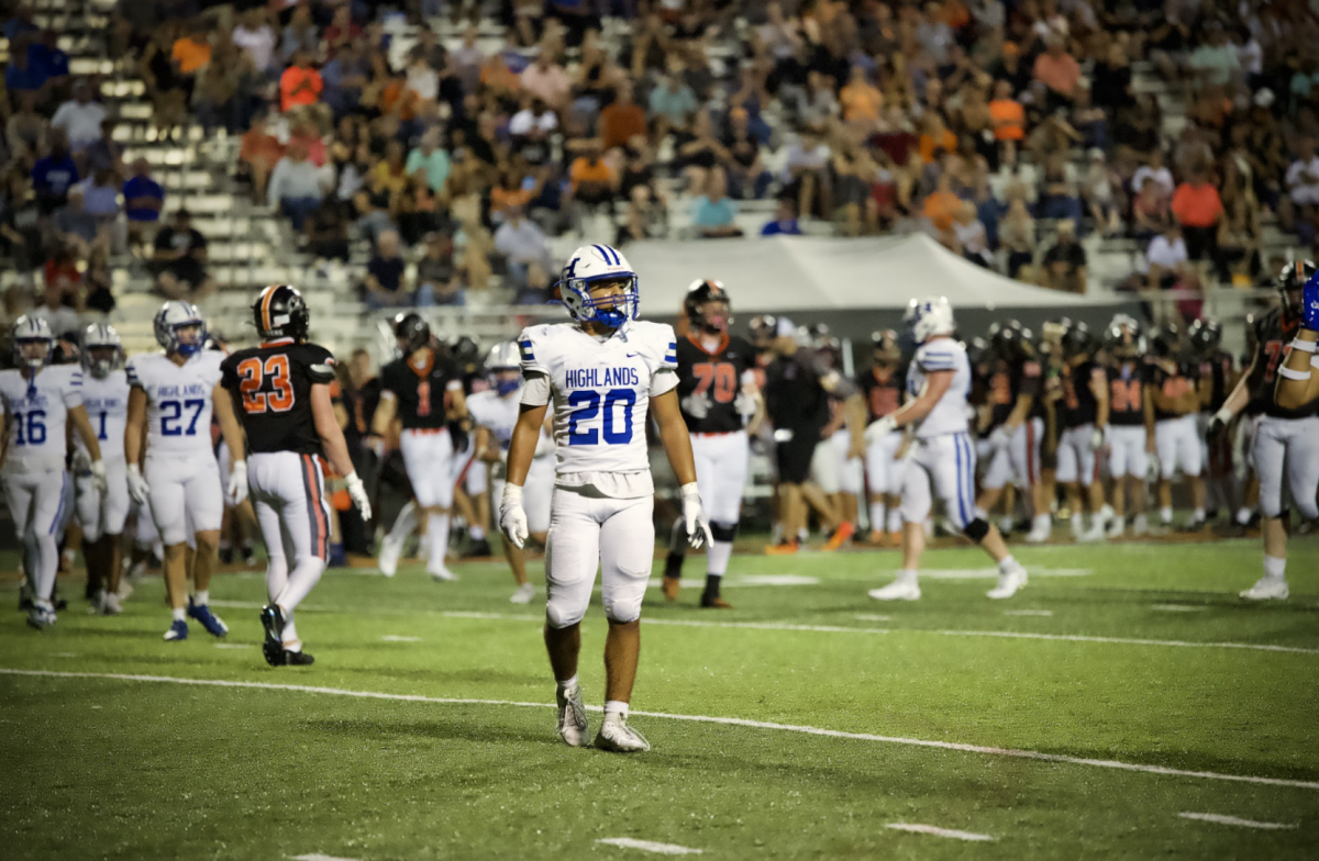 Gabe Williams (10) walks back to his position as he listens to his coach from the sideline.